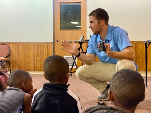 Andrew Ashur teaching robotics to children